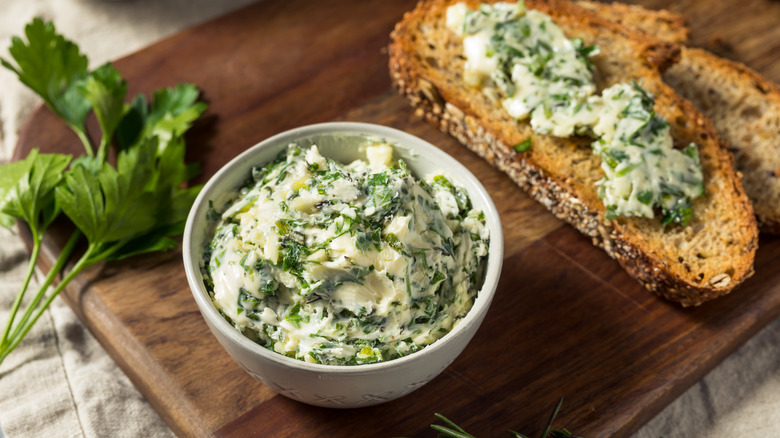 Herbed butter in bowl and on bread