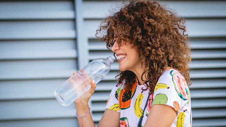 Woman drinking bottled water