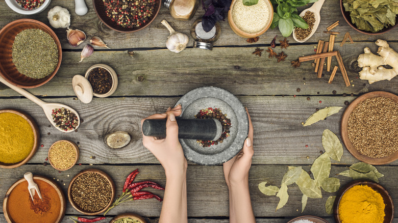 grinding spices with mortar pestle 