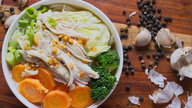 Chicken noodle soup with cabbage, broccoli, and green onions