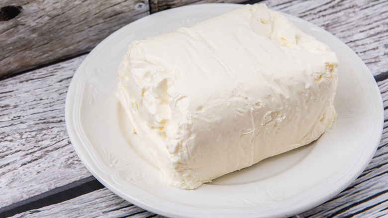 Bock of cream cheese on plate