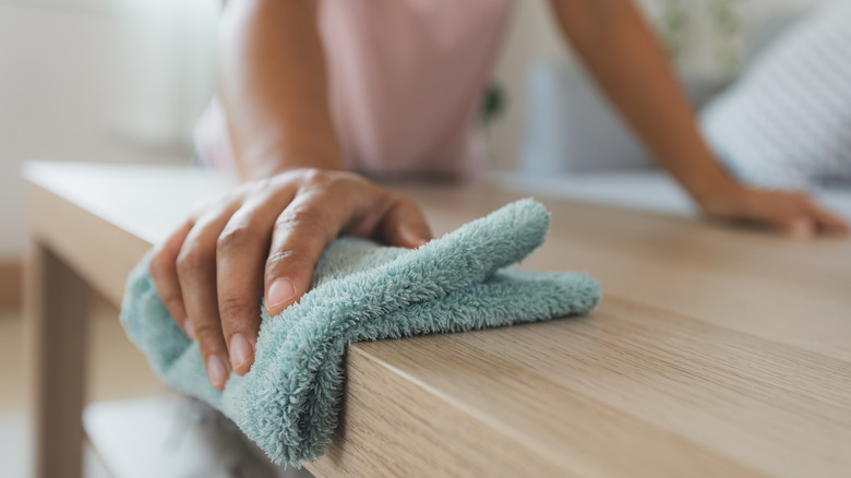 Someone cleaning with a towel