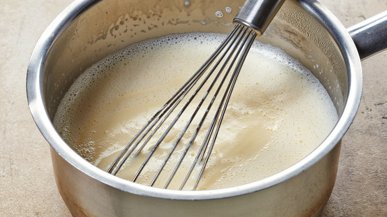 milk and cream cooking in pot