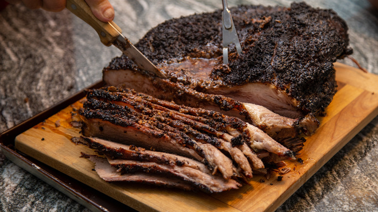 Sliced brisket on wooden cutting board