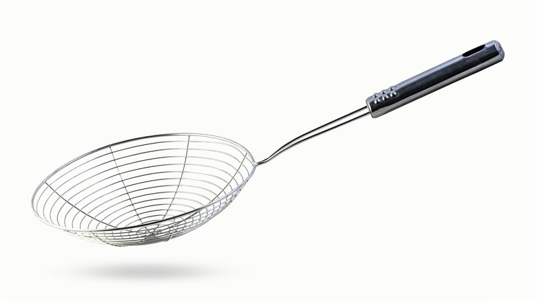 Spider strainer on white background