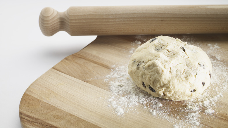 scone dough on the counter with a rolling pin