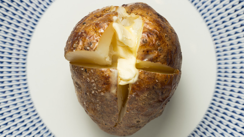 crispy, fluffy baked potato with butter