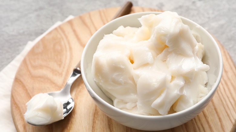 A bowl of lard on a wooden board