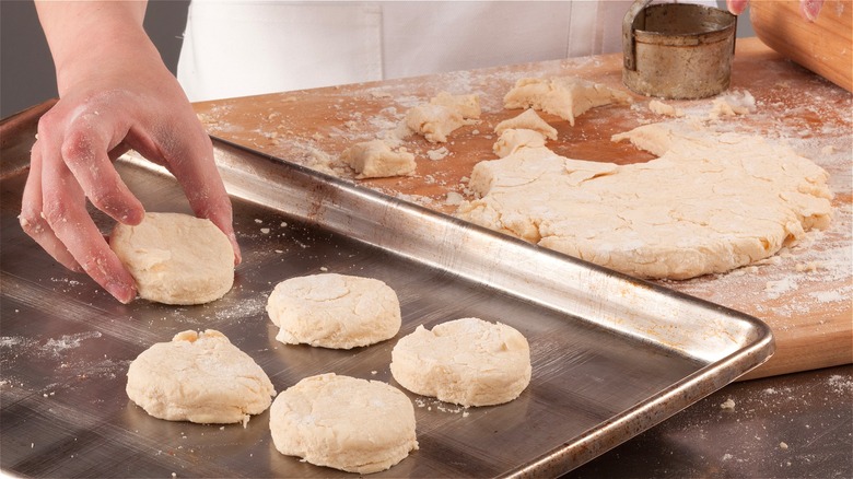 Raw biscuit rounds on sheet pan 