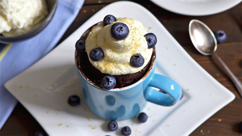 Mug cake with cream and blueberries 