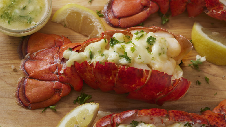 Lobster tail on wooden board