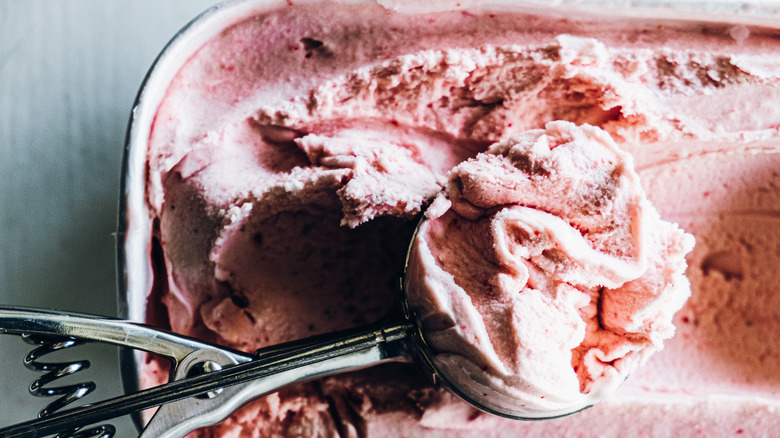 Ice cream getting scooped out of container