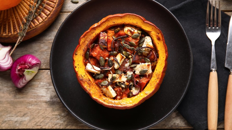 Pumpkin stuffed with herbs, cheese, pumpkin seeds