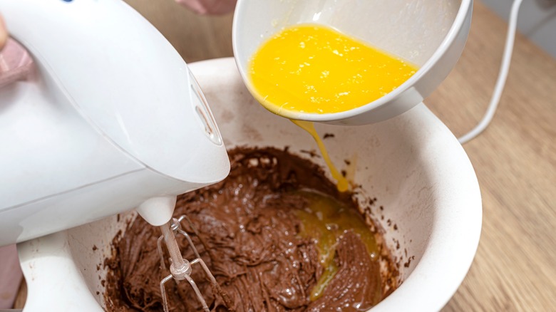 pouring melted butter into batter