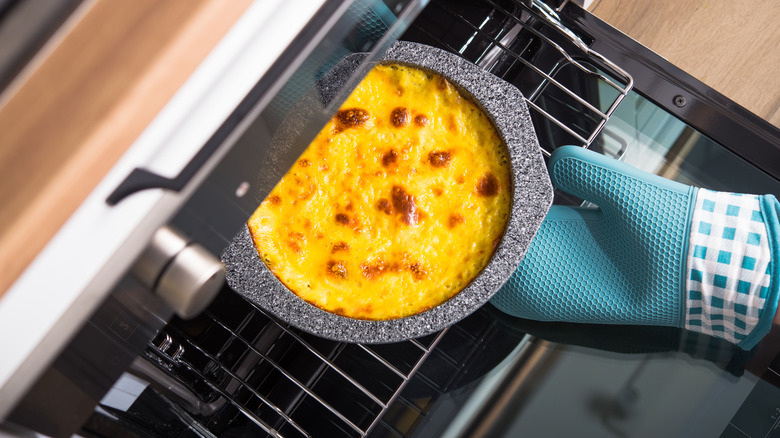 removing baked cheesecake from oven