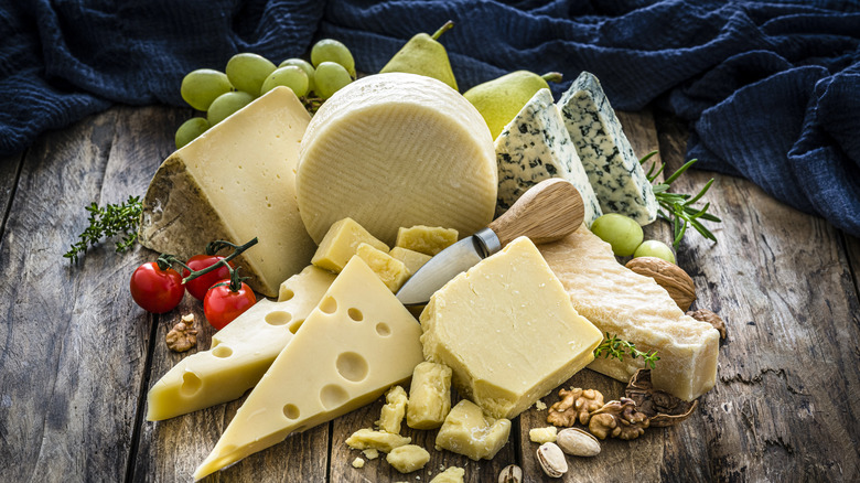 Wooden table full of cheese