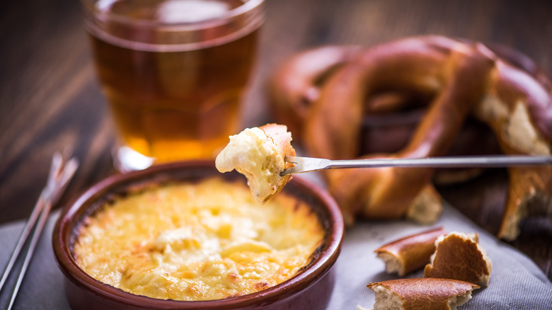 Cheese fondue with pretzels and beer