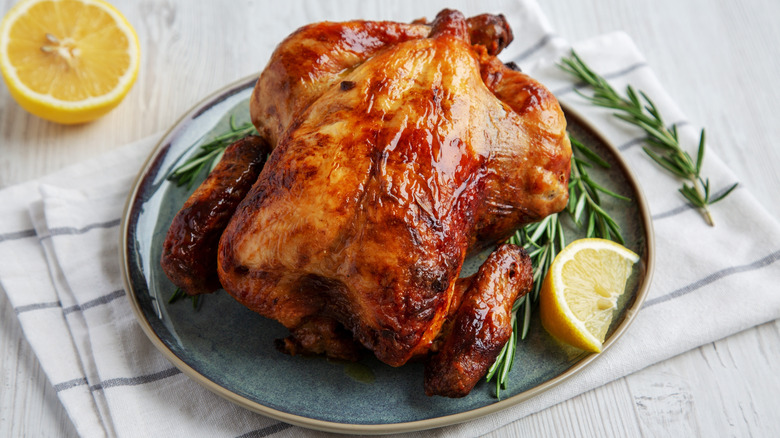 roast chicken plated with lemon