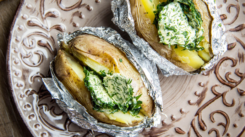 herbed butter on baked potatoes