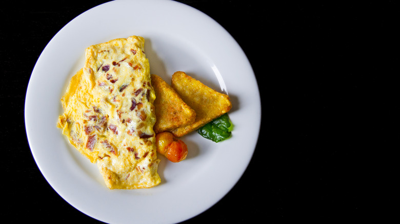 Omelette and hash browns on plate