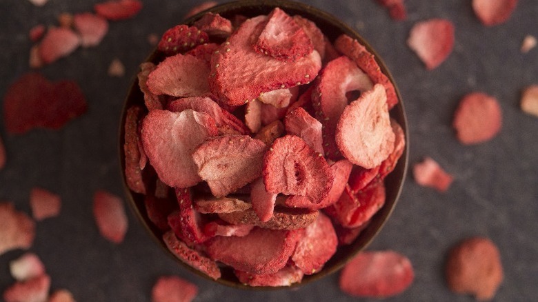 freeze-dried strawberries in cup on slate