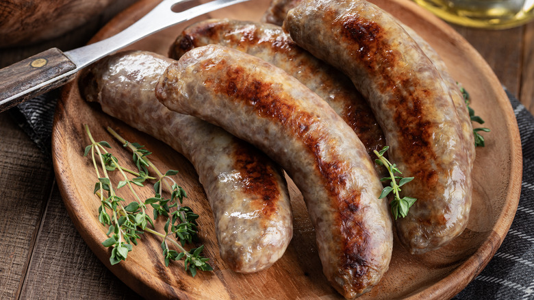 Fried bratwursts on.a wooden plate