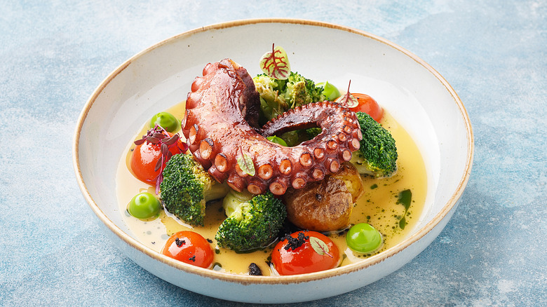 Octopus tentacle in oil with veggies