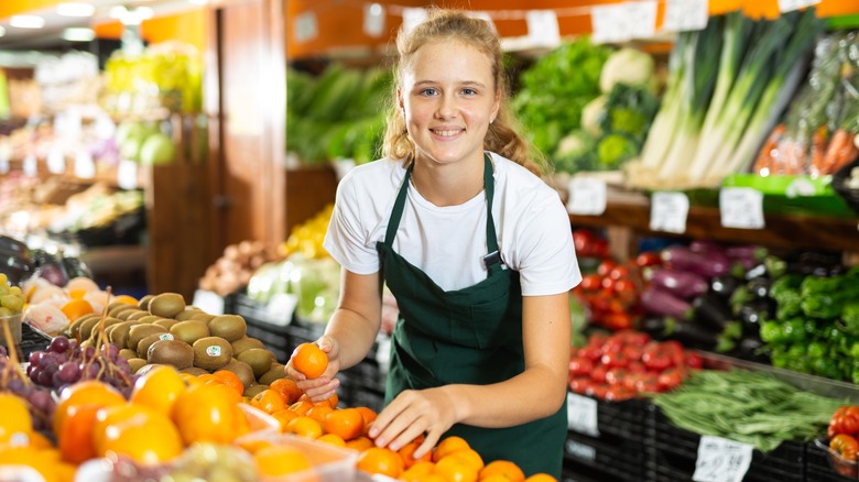 grocery store employee sorting produce