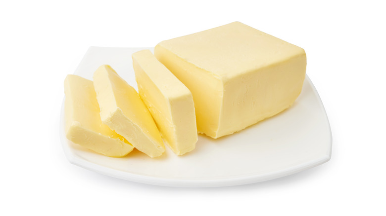 Sliced butter on white plate