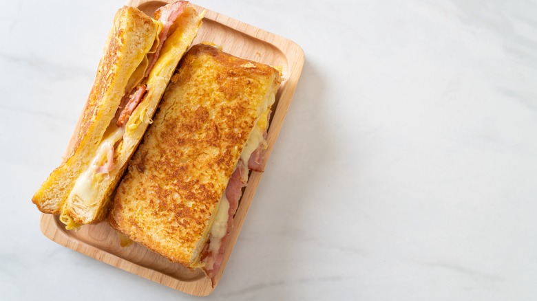 French toast ham and cheese on wood plate