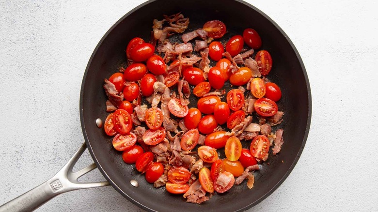 tomatoes and cooked prosciutto in a pan