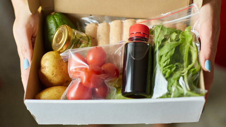 Person holding meal kit