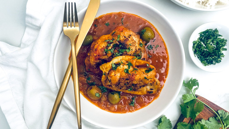 chicken fricassee in bowl with rice and cilantro