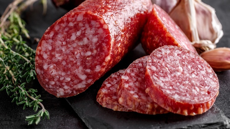 sliced salami on cutting board 