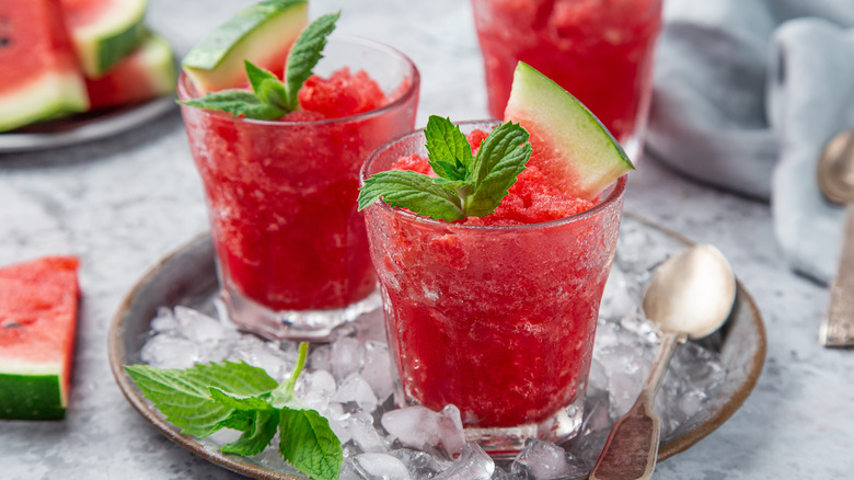 Two red granitas on a metal serving tray