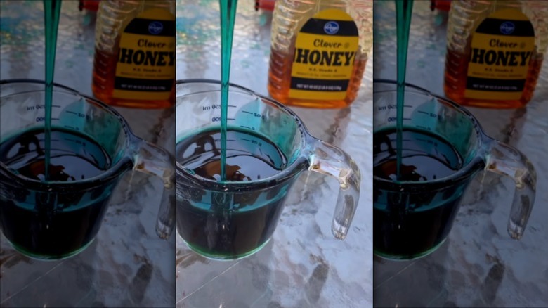 Blue Jell-O powder being mixed with honey