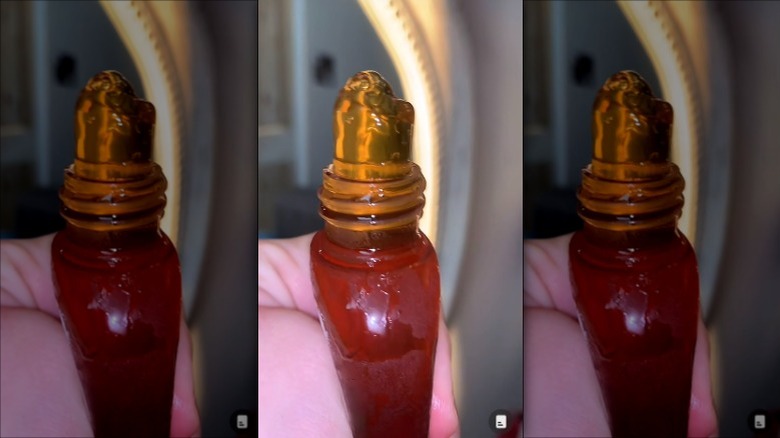 Person squeezing frozen honey out of bottle