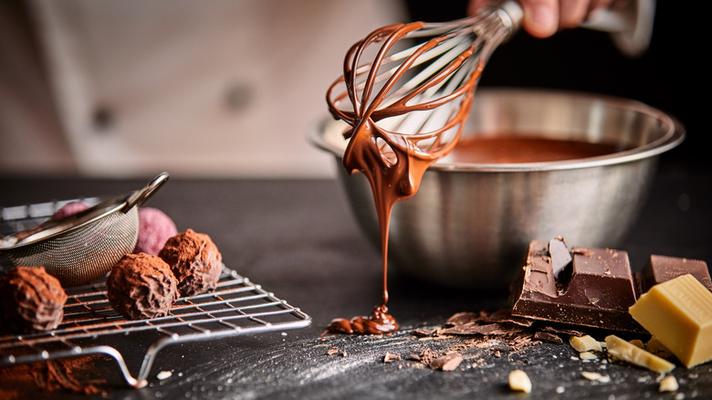 person making melting chocolate for cake balls