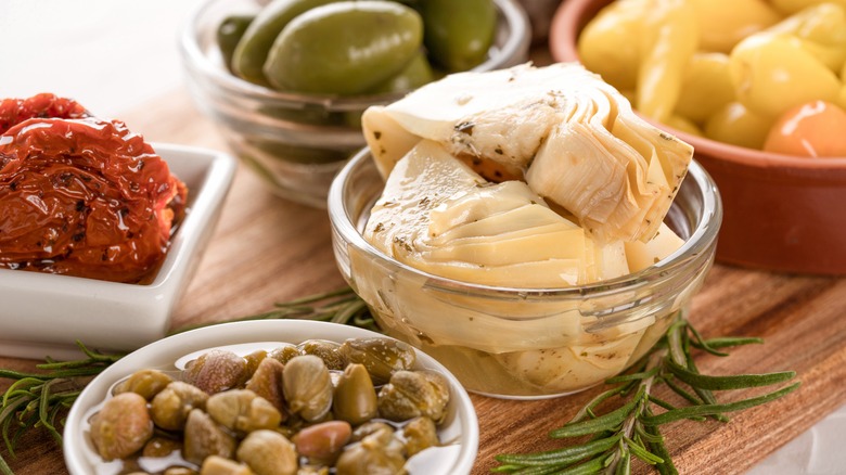 Artichokes and olives in bowls