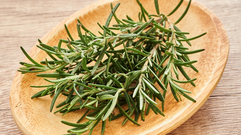 Fresh rosemary on a wooden platter