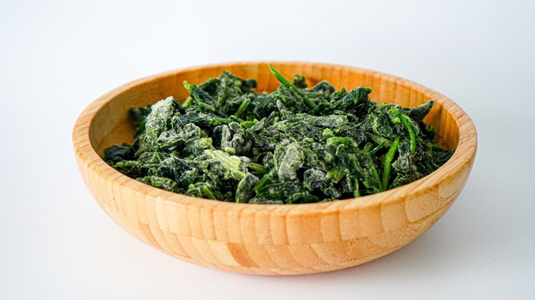 Frozen spinach in a wooden bowl