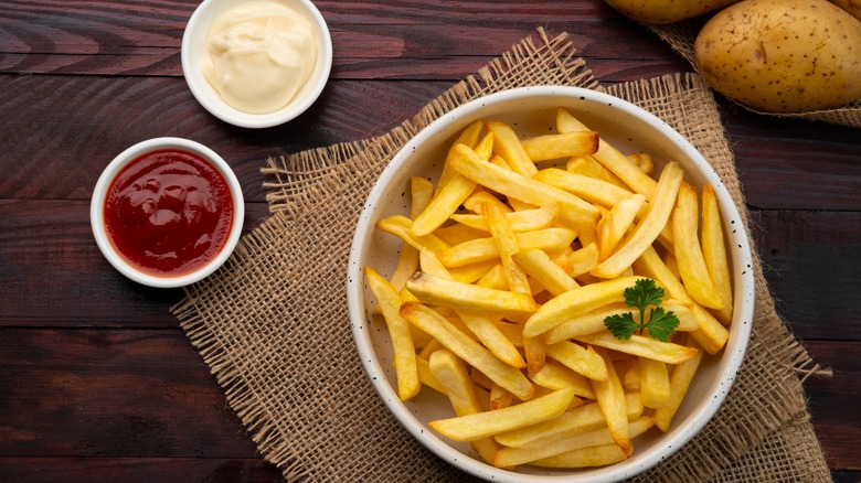 ramekins of mayo and ketchup beside French fries