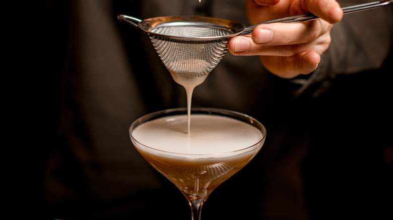 Straining a coffee espresso into a glass