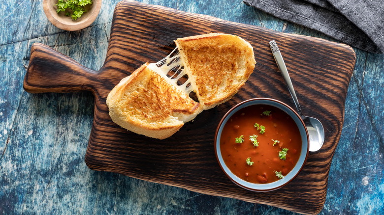 Grilled cheese and soup on a cutting board