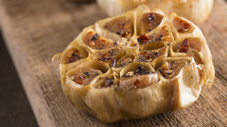 Roasted head of garlic on a board