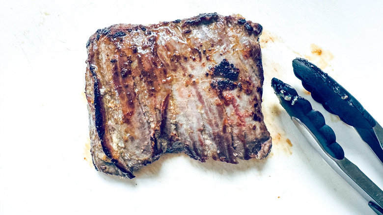 cooked steak on cutting board