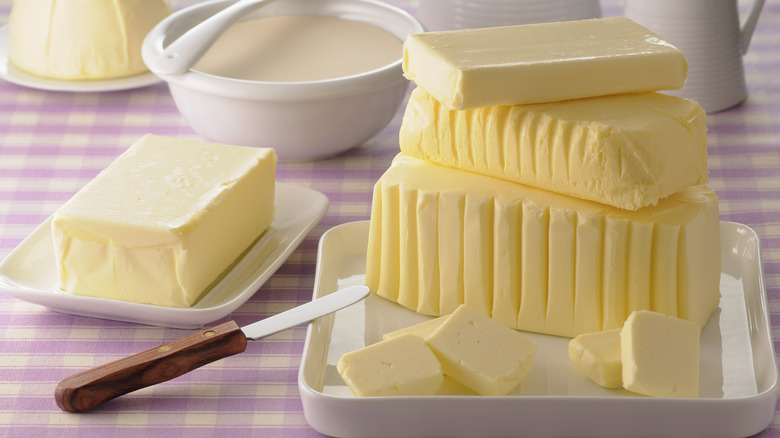 various sticks of butter with knife