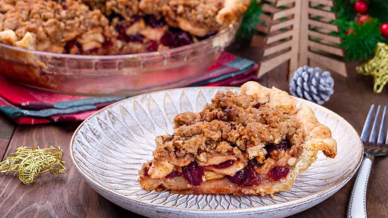 Slice of apple cranberry pie on plate