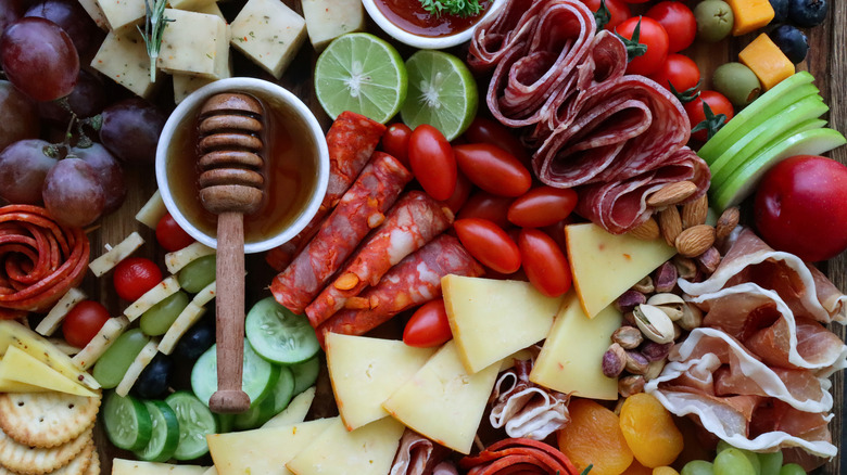 various charcuterie ingredients laid out on a board