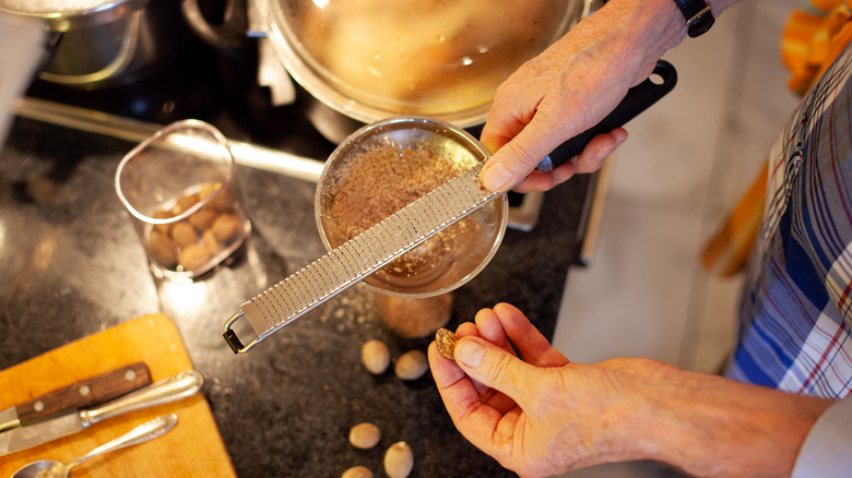 Person grating nutmeg